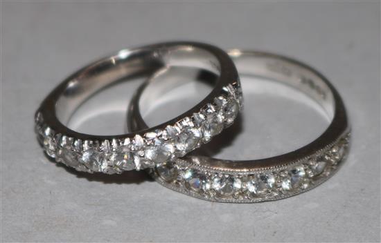 Two 18ct white gold half eternity rings, both set with colourless stones.